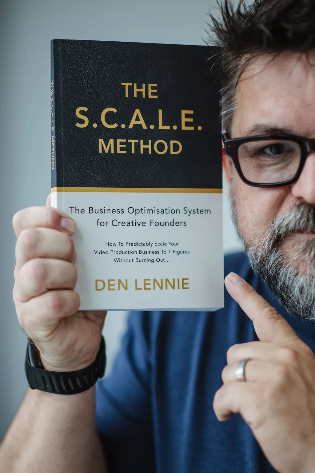 Den Lennie holding a signed copy of The S.C.A.L.E. Method