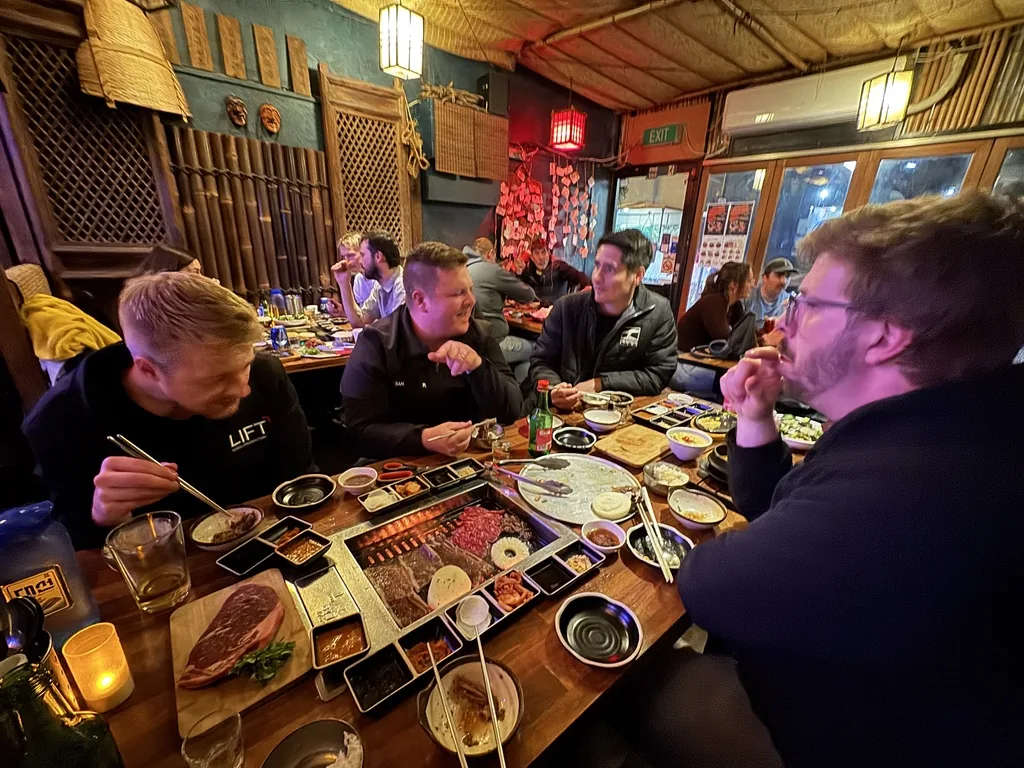 Members sharing dinner at a Korean BBQ restaurant